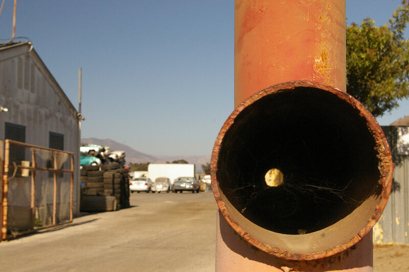 Rusty pipe at auto salvage yard