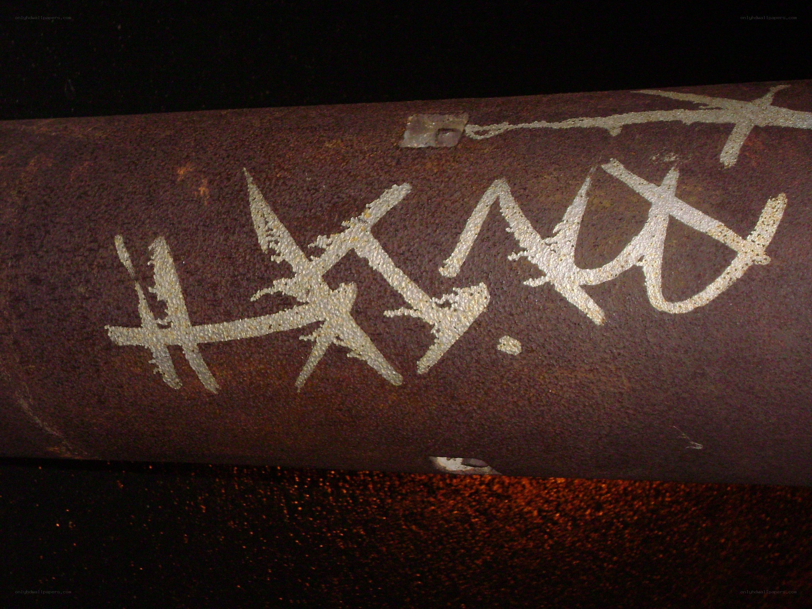 rusty pipe with graffiti