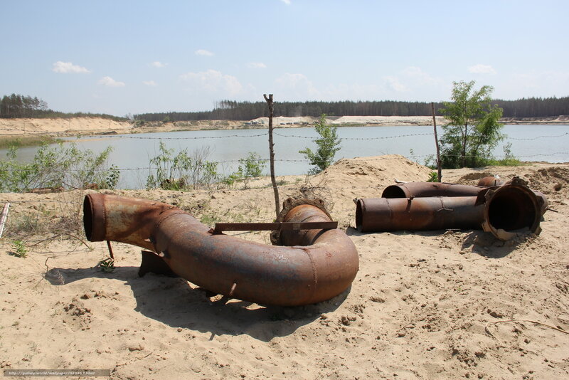 Rusty pipes near a lake