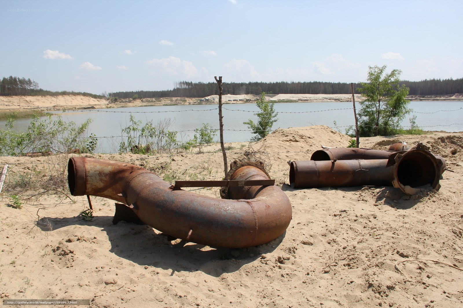 Rusty pipes near a lake