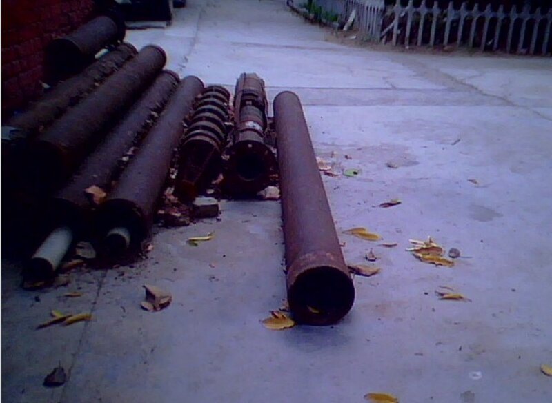 Rusty pipes on concrete ground