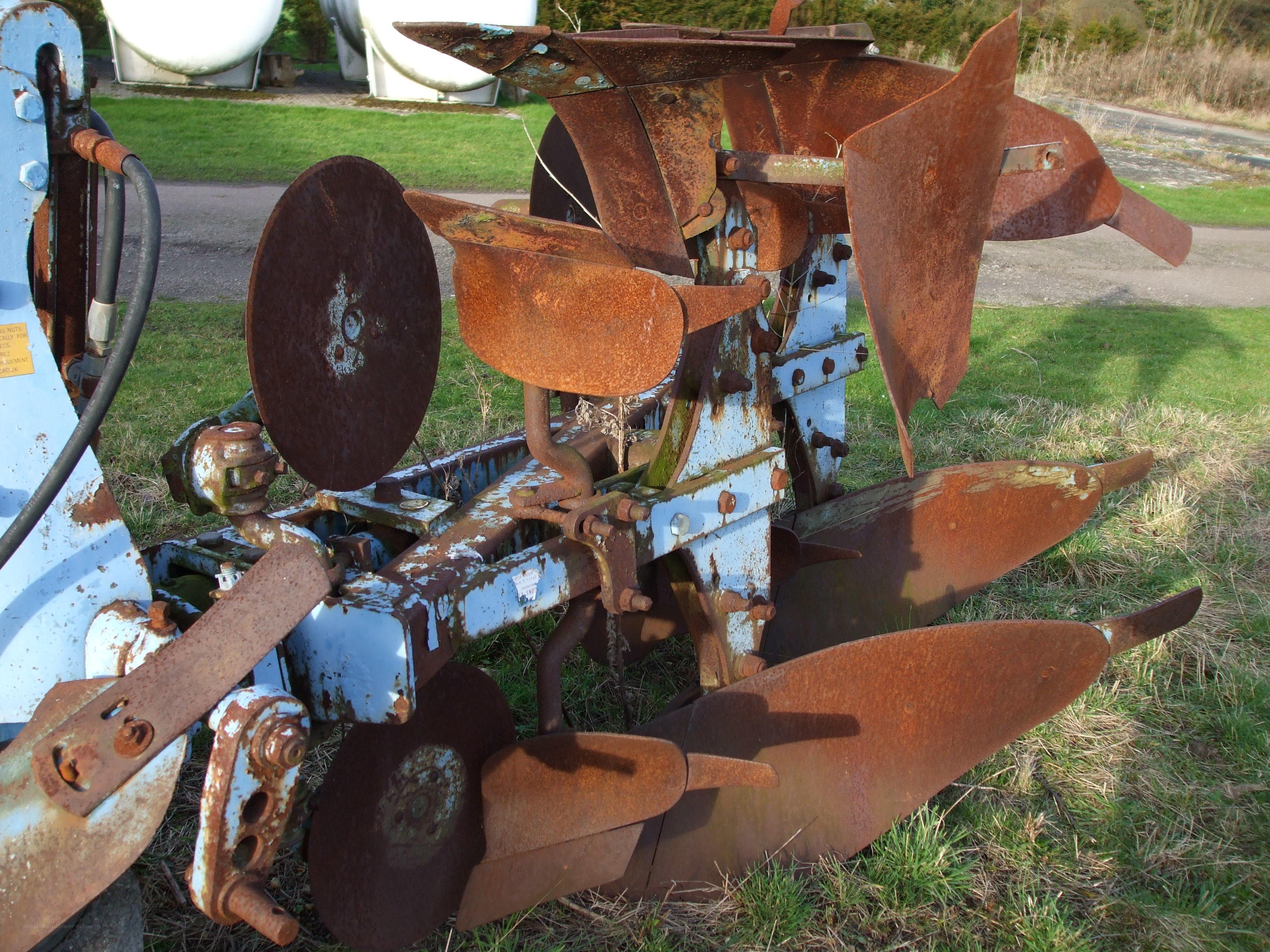 Rusty plow on grass