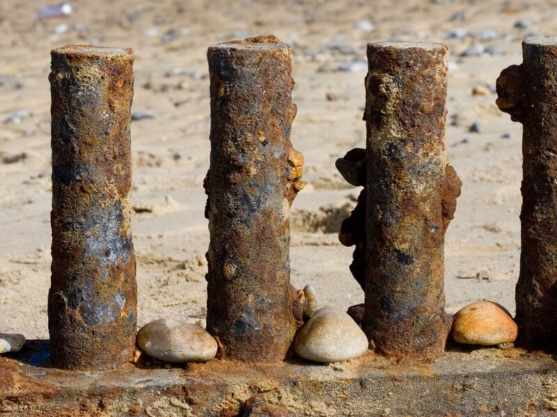 Rusty posts on a beach