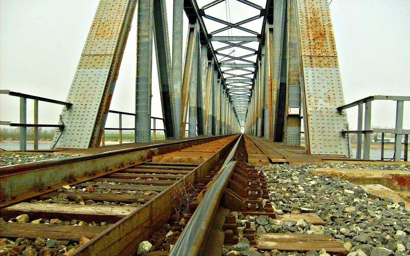 Rusty railway bridge over river