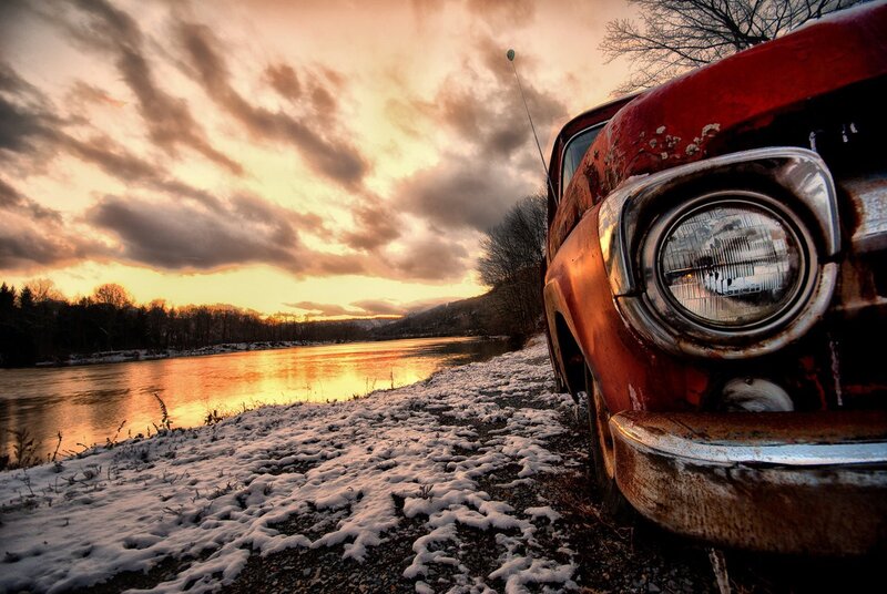 Rusty Red Car by River — Dramatic, Sunset