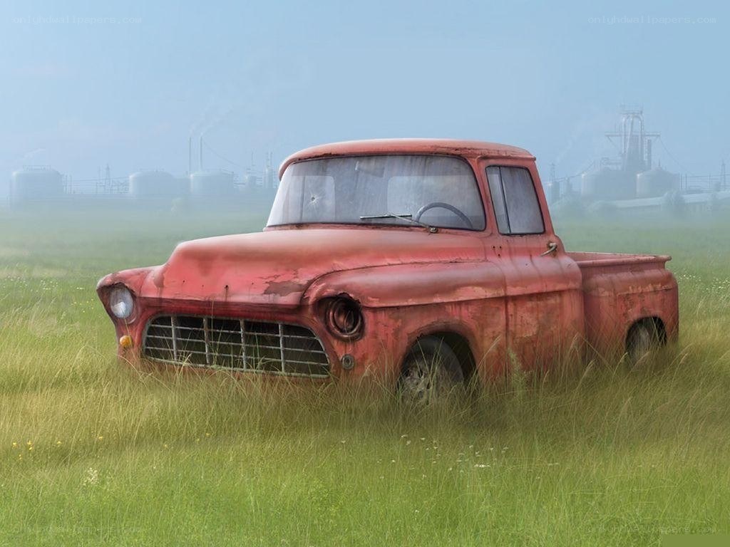 Rusty red truck in a field