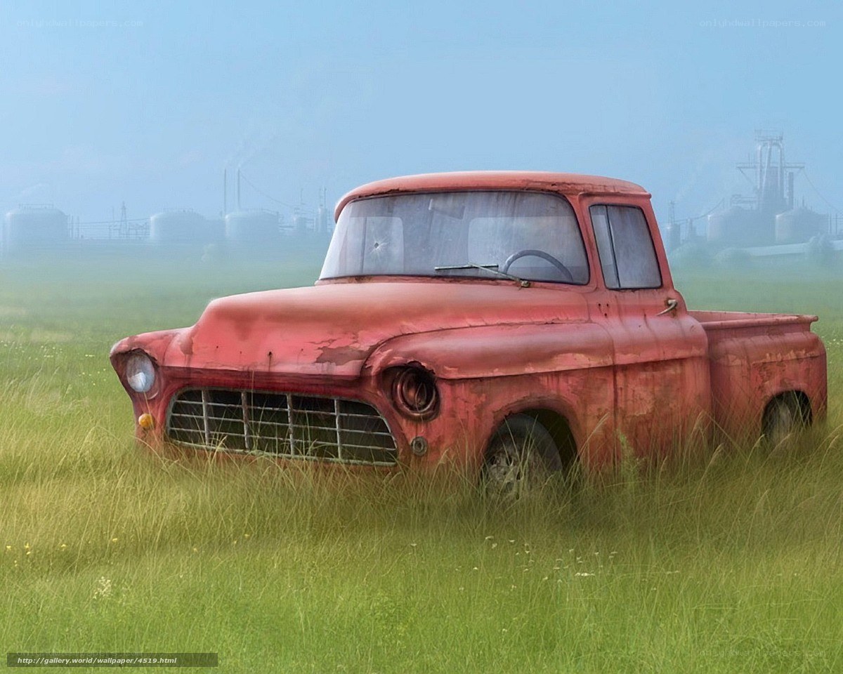 Rusty red truck in a field