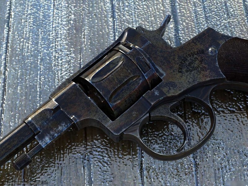 rusty revolver on wet surface