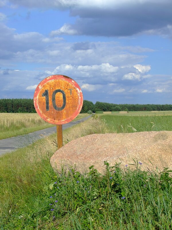 Rusty road sign in rural landscape