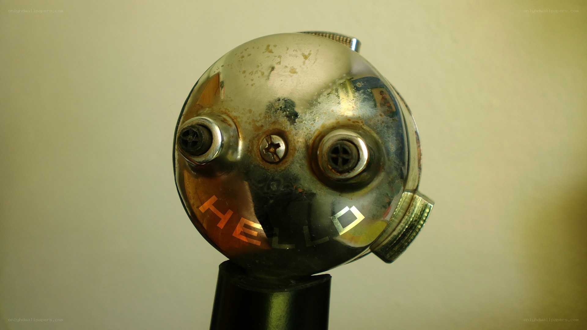 Rusty robot head with 'HELLO' text