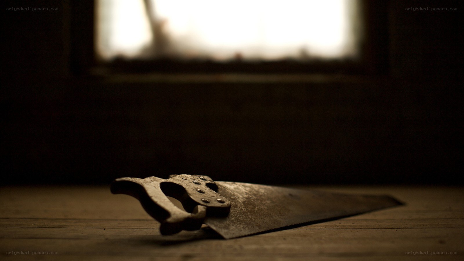rusty saw on wooden surface