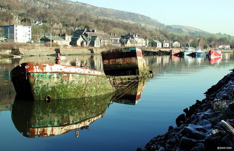 Rusty shipwreck in a harbor