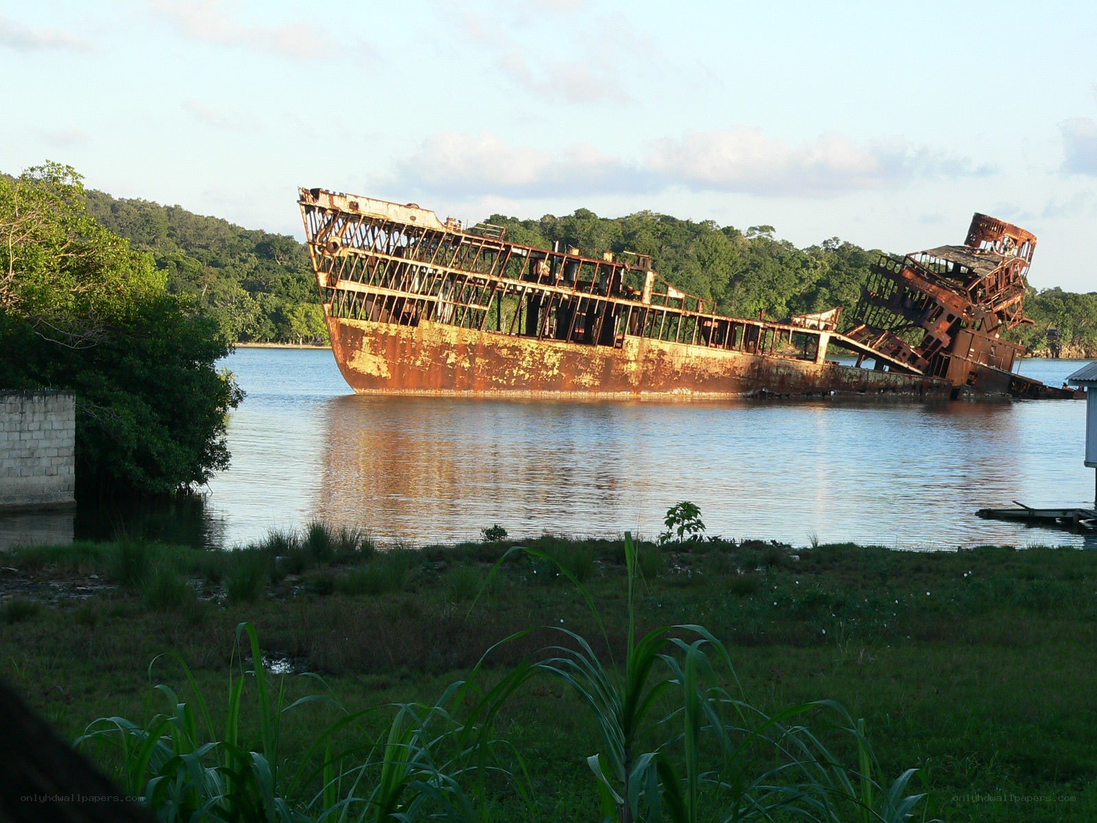 Rusty shipwreck in calm water