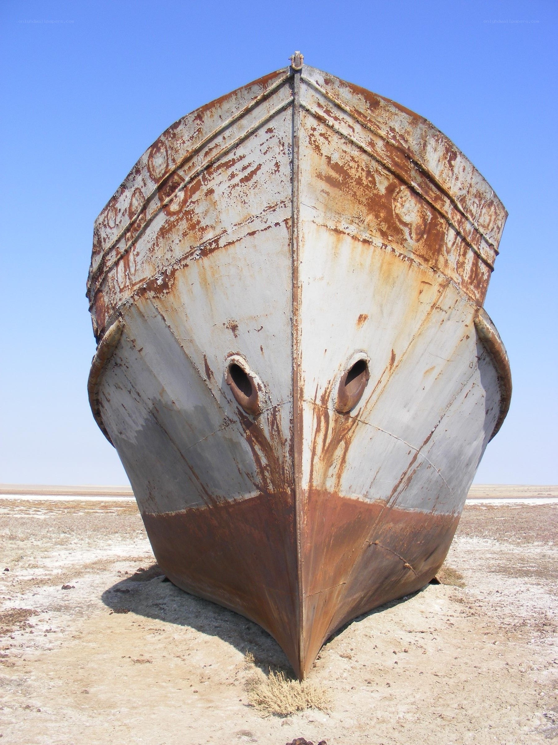 Rusty shipwreck in desert