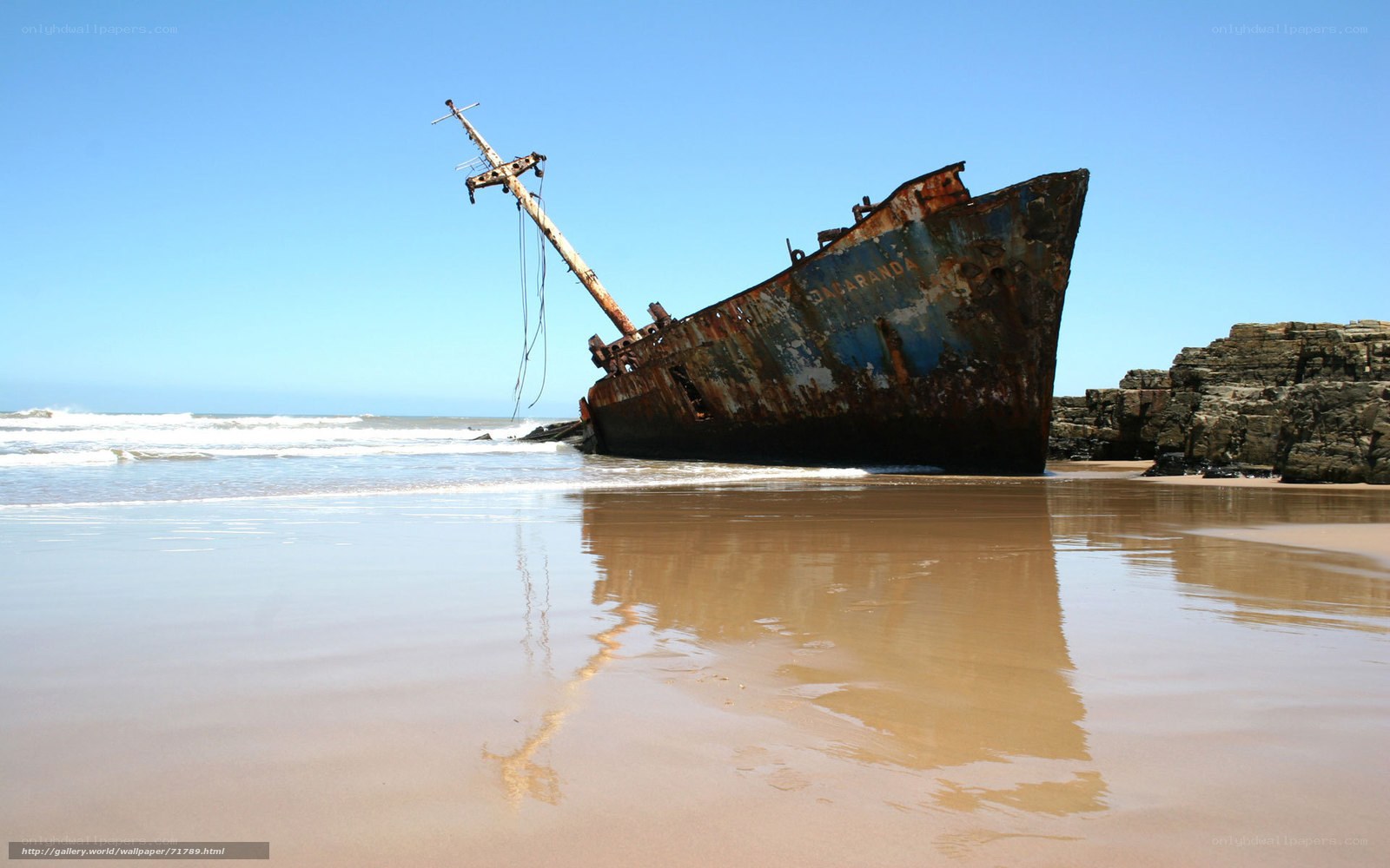 Rusty shipwreck on beach