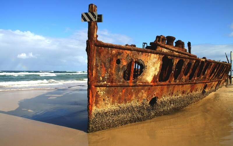 Rusty Shipwreck on Beach — Blue, Dramatic, Afternoon, Photograph