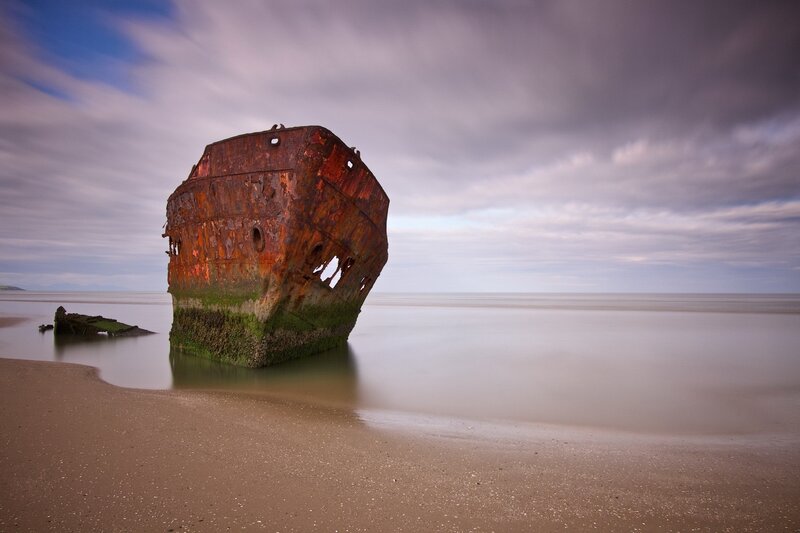 Rusty Shipwreck on Beach — Brown, Dramatic, Sunset