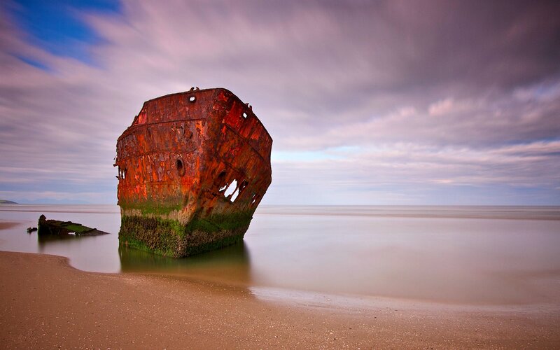 Rusty Shipwreck on Beach — Brown, Dramatic