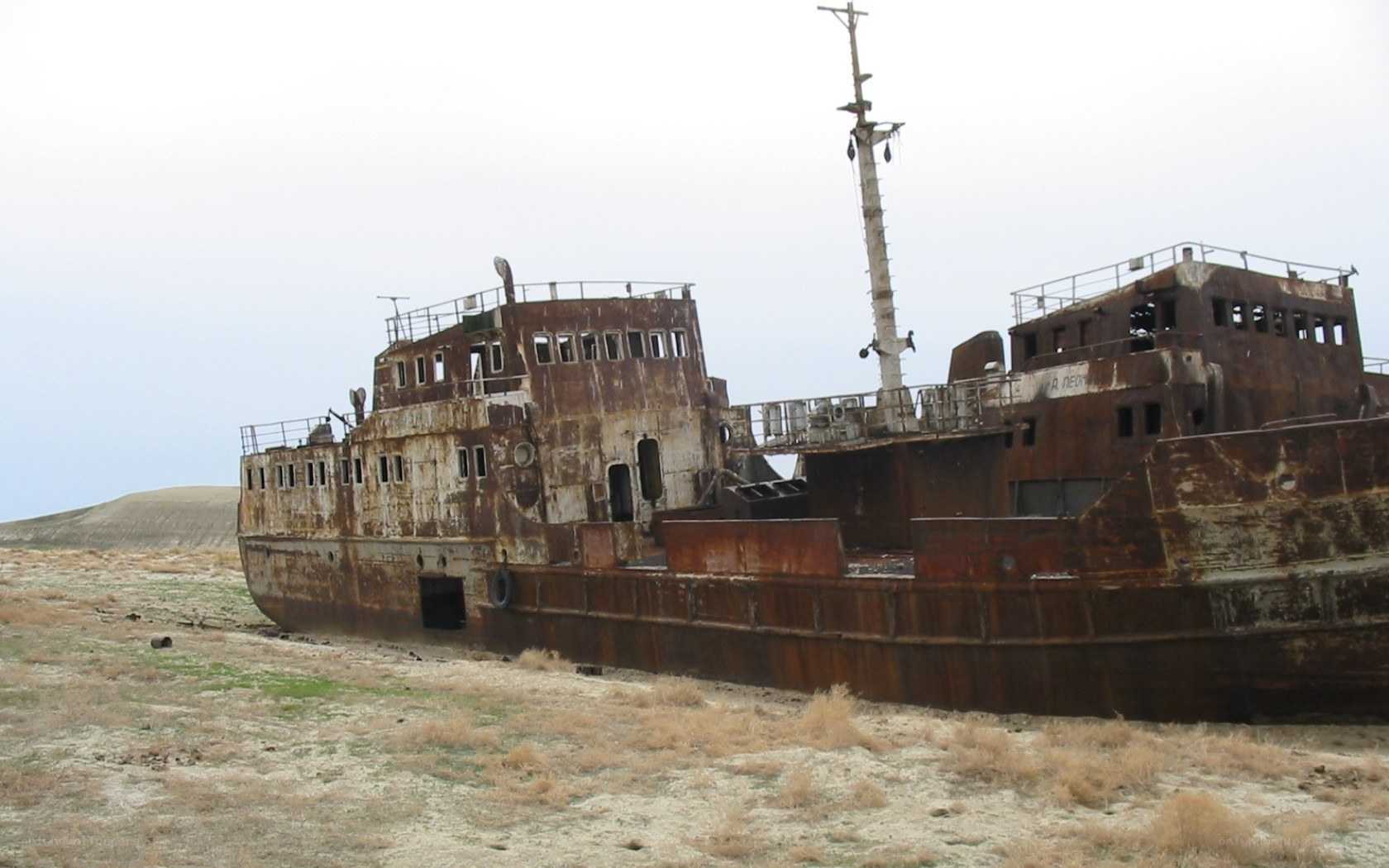 Rusty shipwreck on dry land