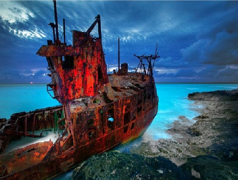 Rusty shipwreck on rocky shore