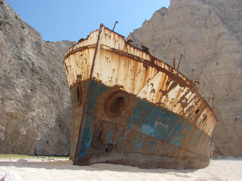Rusty shipwreck on sandy beach