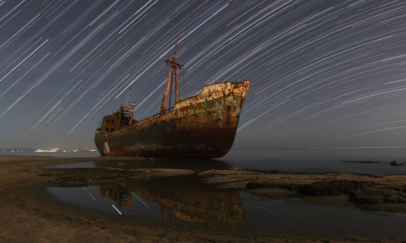 Rusty Shipwreck on Shore — Dark Blue, Dramatic