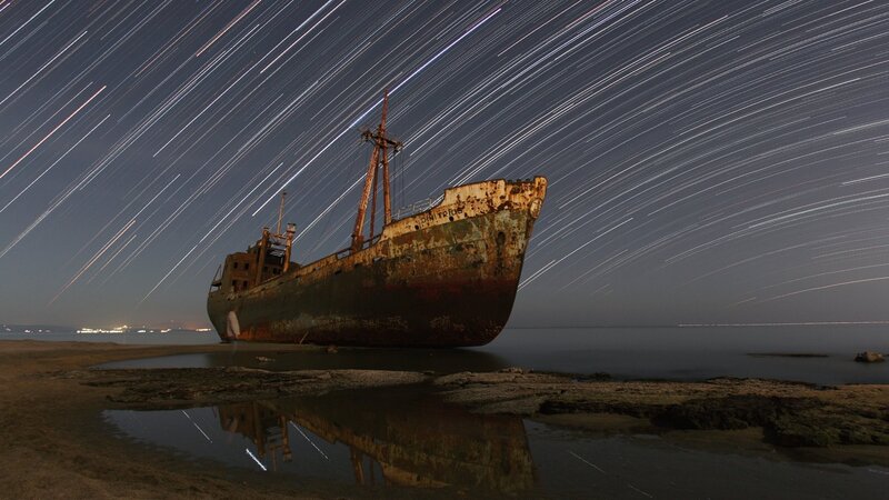 Rusty Shipwreck on Shore — Dark Blue