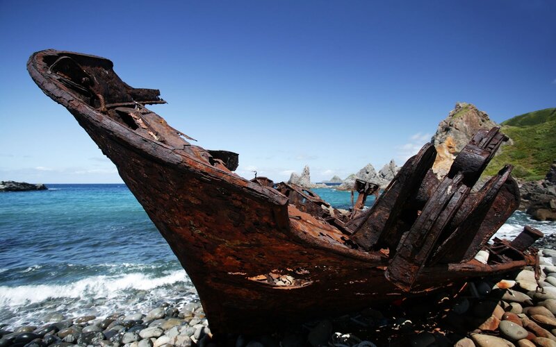 Rusty Shipwreck on Shore