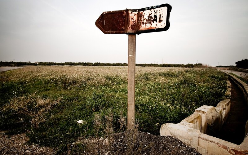 Rusty Signpost in Field — Green, Desolate