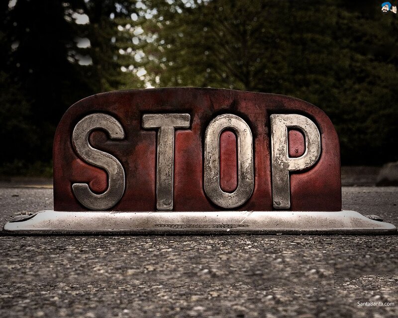 Rusty stop sign on pavement