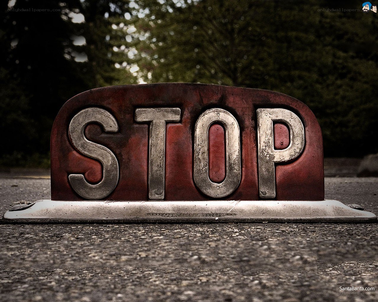 Rusty stop sign on pavement