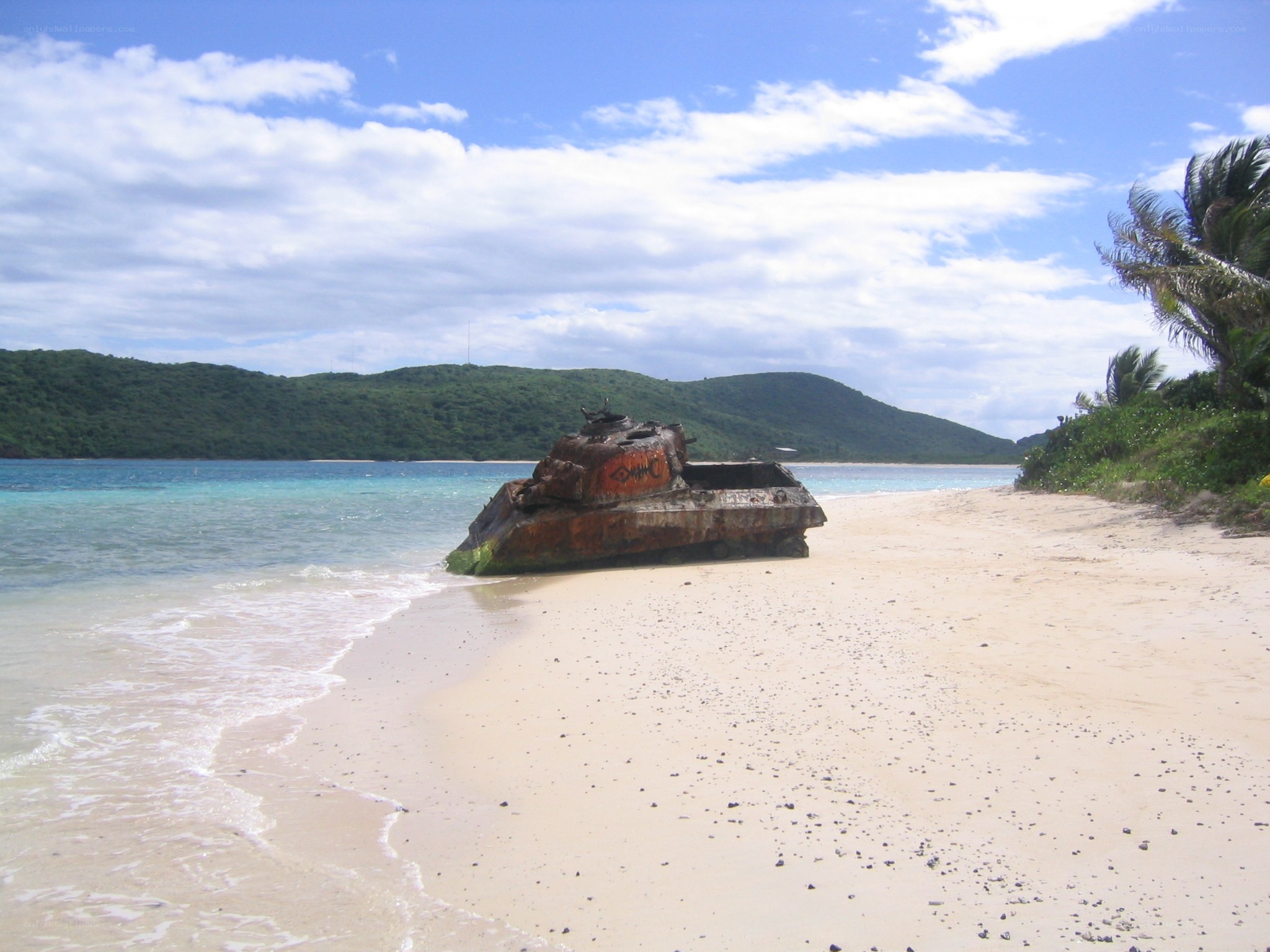 Rusty tank on tropical beach