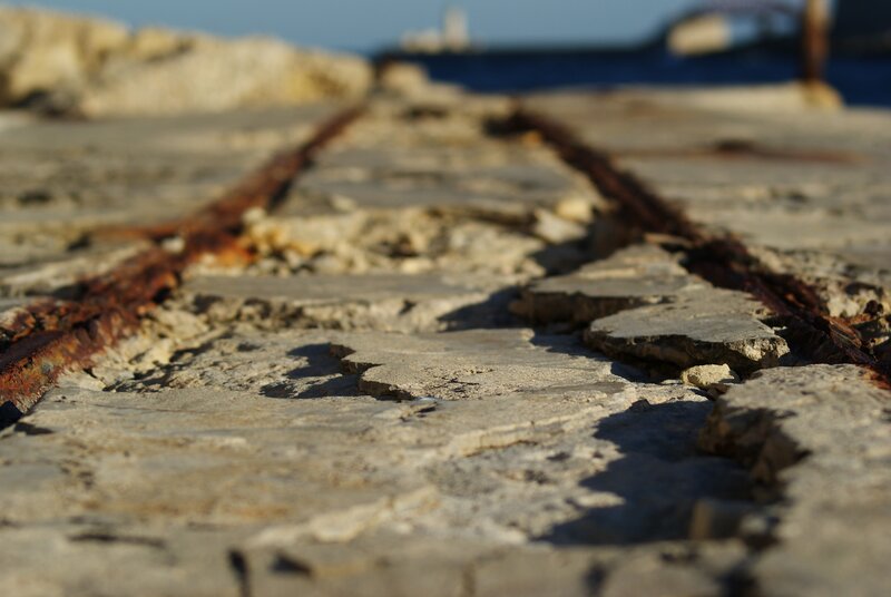 Rusty tracks on a stone pier