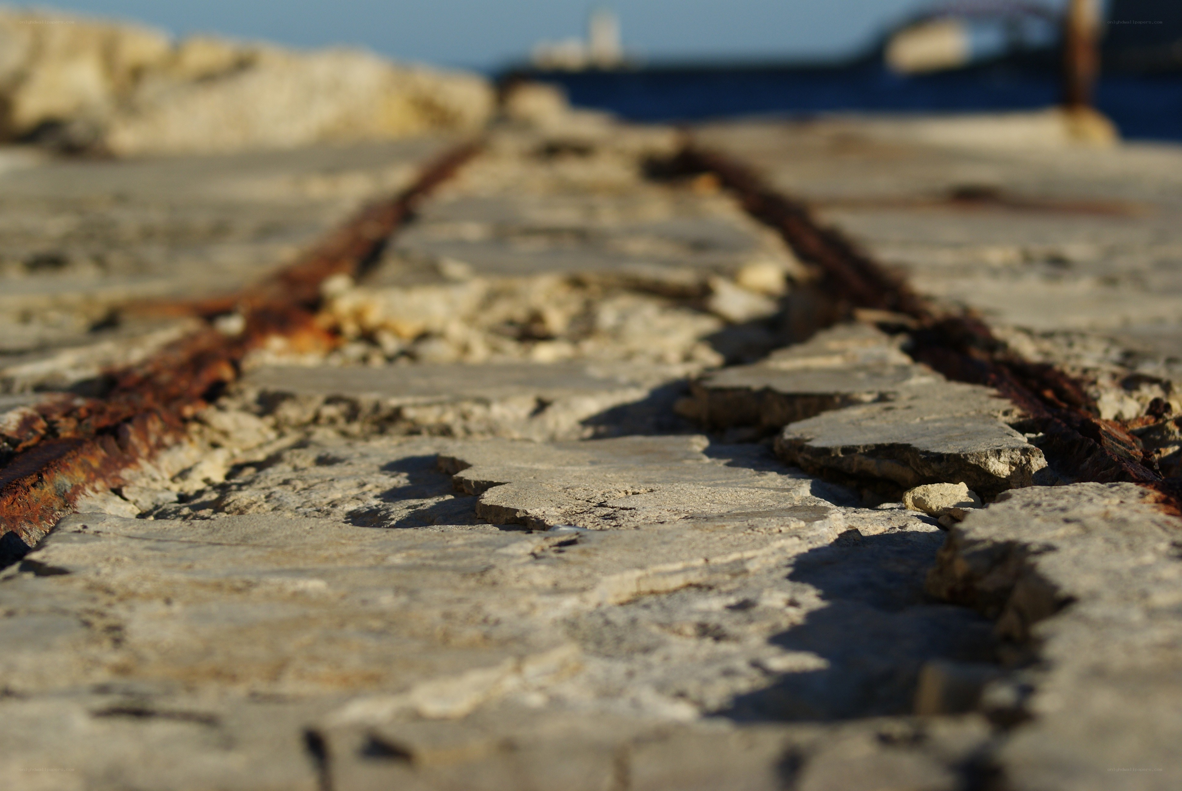 Rusty tracks on a stone pier