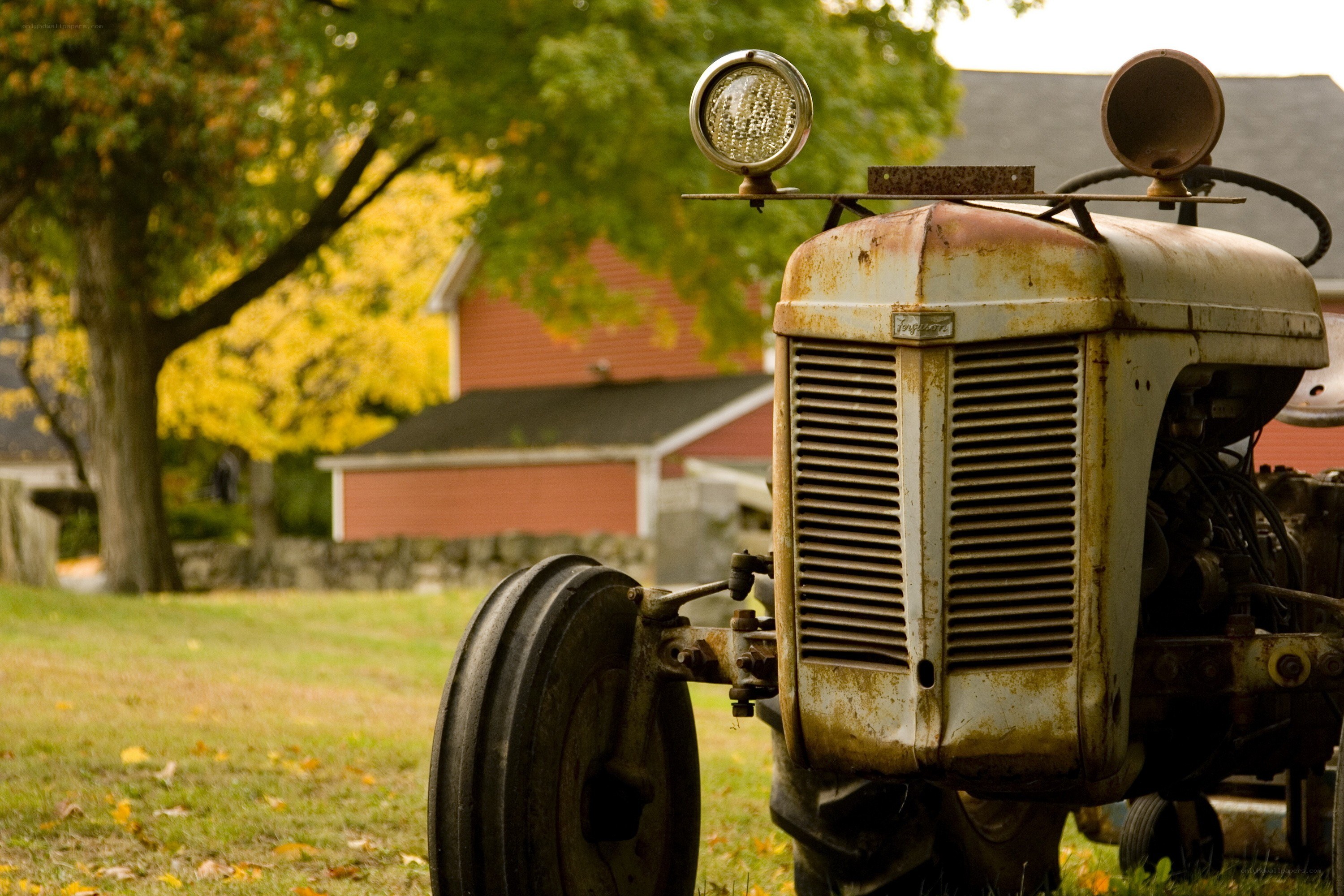 Rusty tractor in autumn field