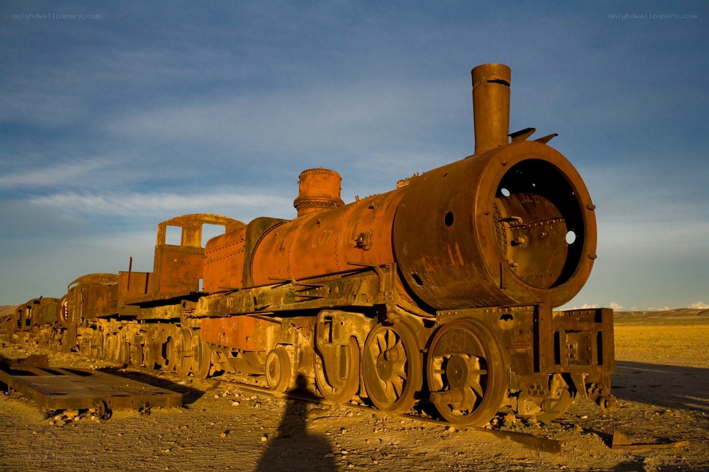 Rusty train graveyard at sunset