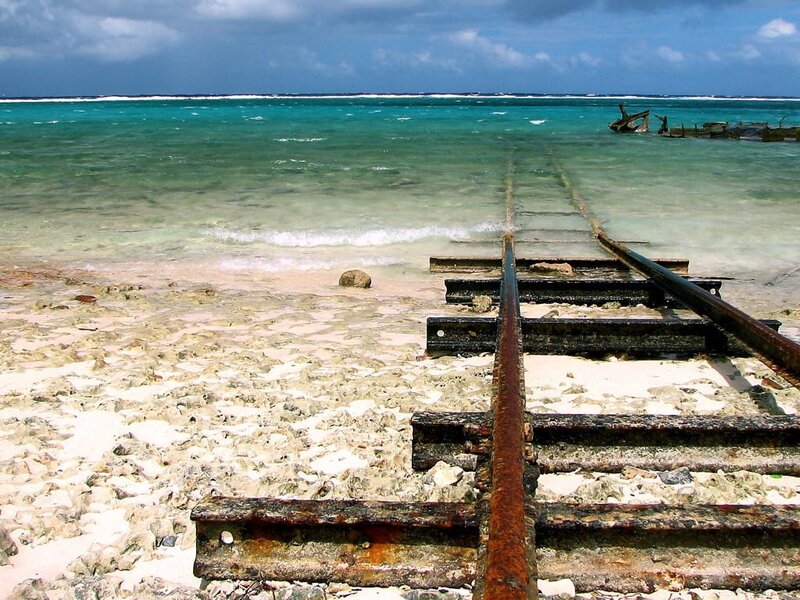 Rusty train tracks on a beach
