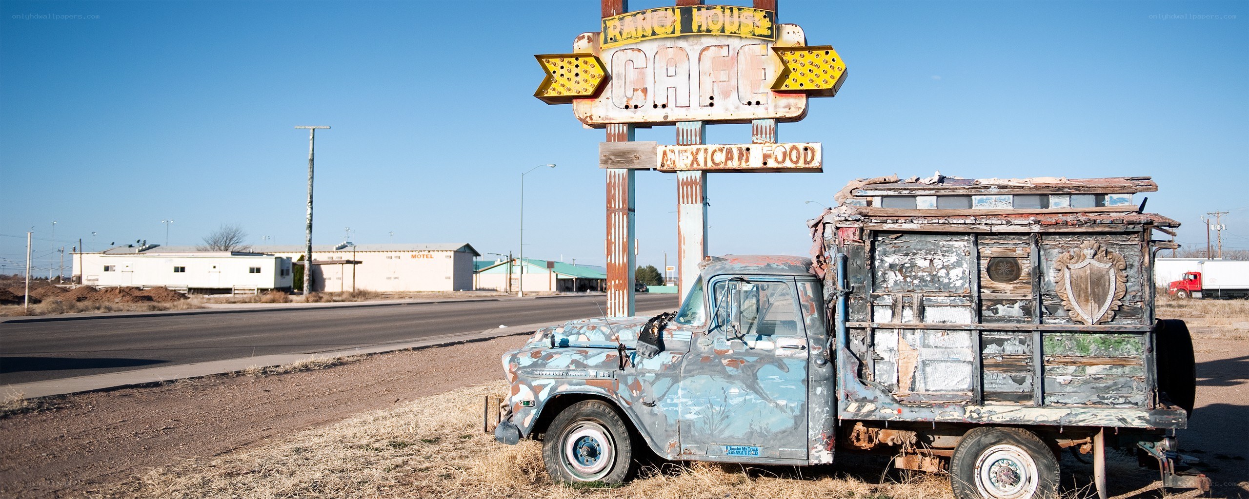 Rusty truck at old cafe sign