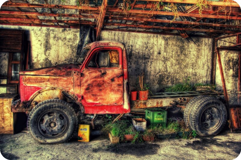 Rusty truck in abandoned shed