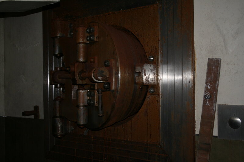 Rusty vault door in dim light