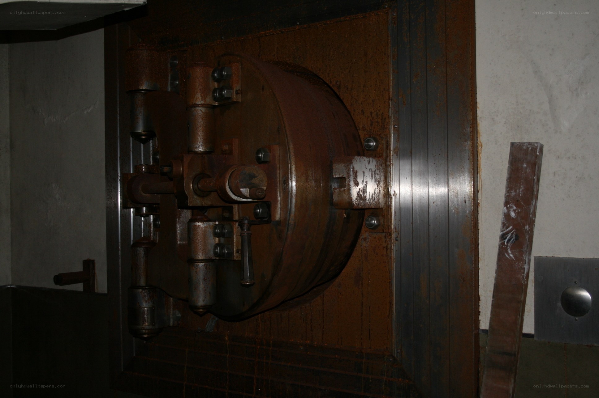 Rusty vault door in dim light