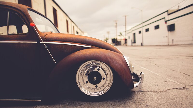 rusty vintage car in alley