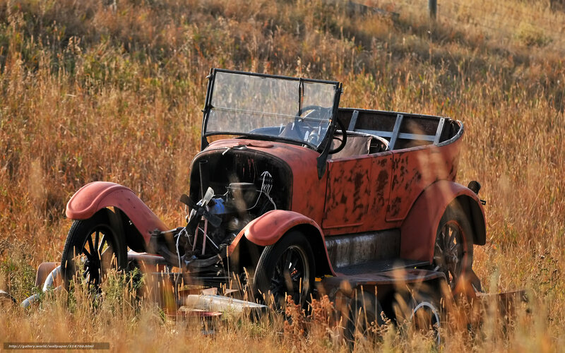 Rusty vintage car in field
