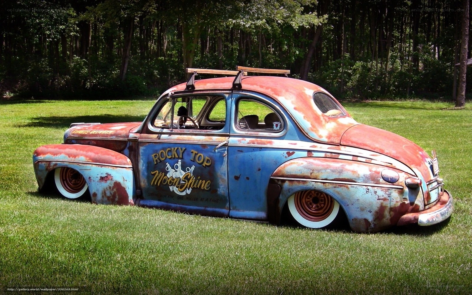 rusty vintage car on grass