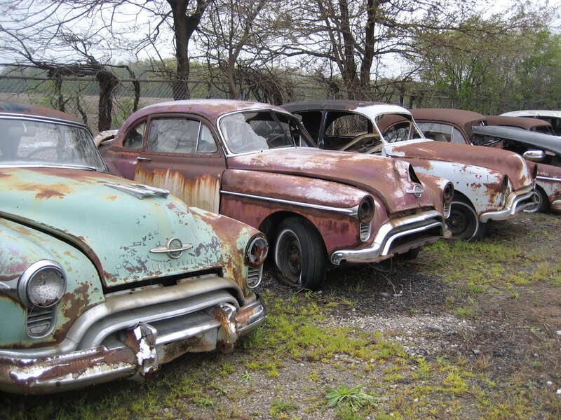 Rusty vintage cars in a junkyard