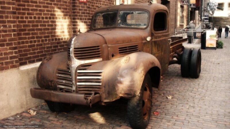 Rusty vintage truck on cobblestone street