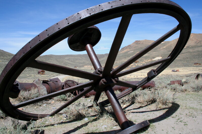 Rusty wheel in desert landscape