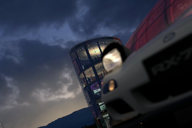 RX-7 at dusk near a modern building