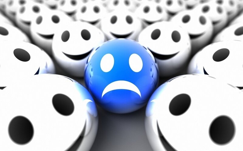 sad blue ball among happy white balls