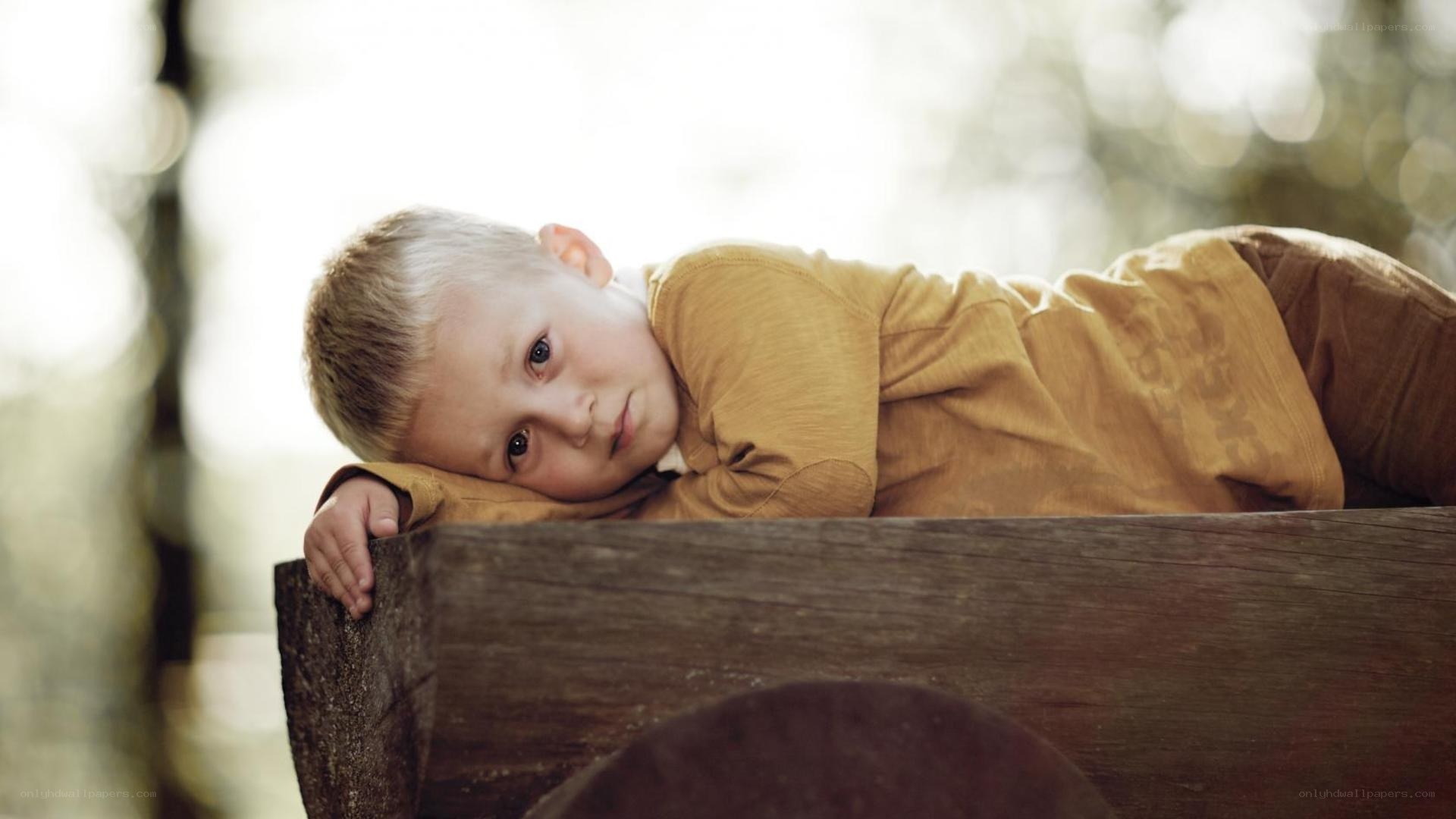 sad boy on wooden cart